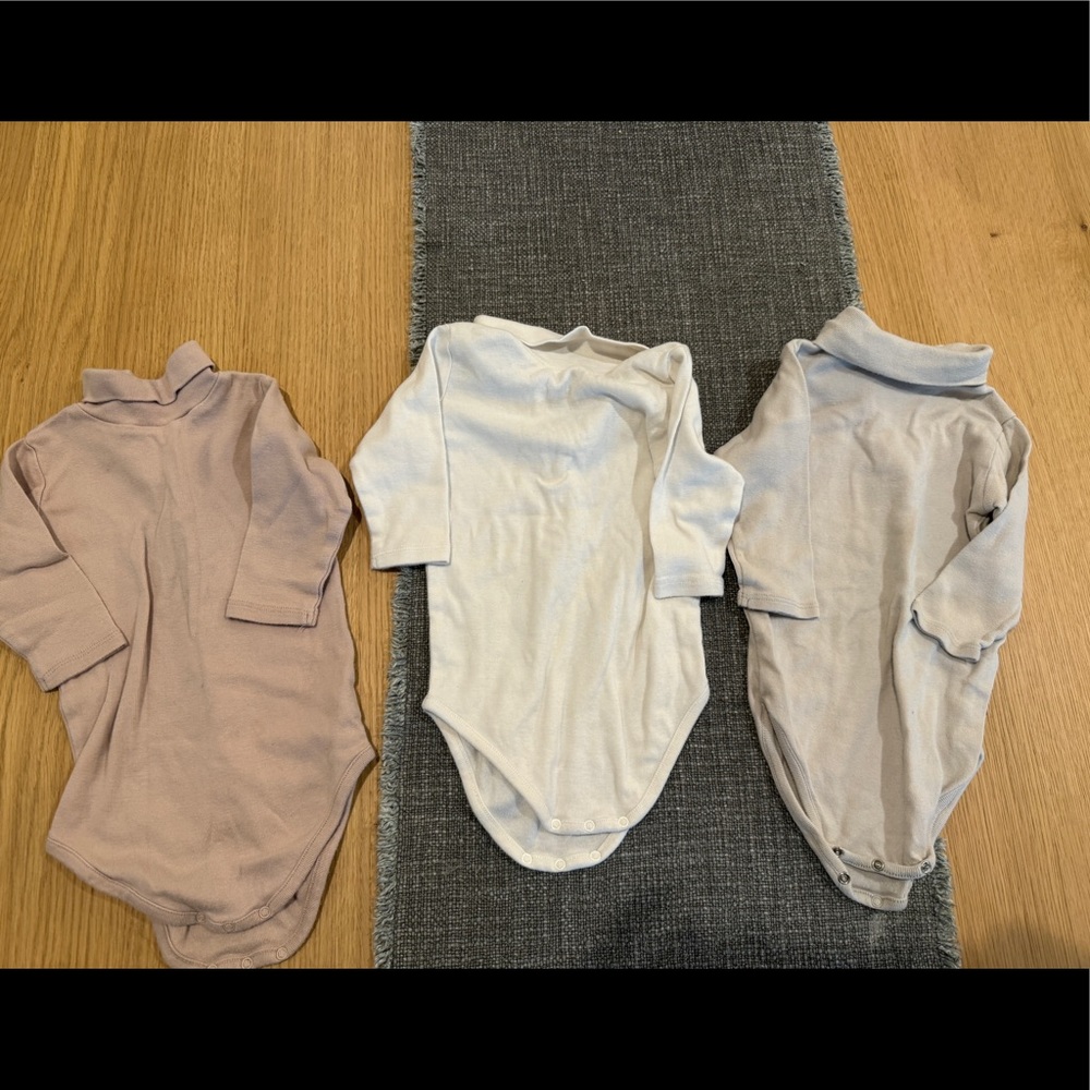 Pack of three Bonpoint turtleneck onesies.
